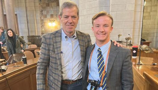 a student poses for a photo with governor jim pillen